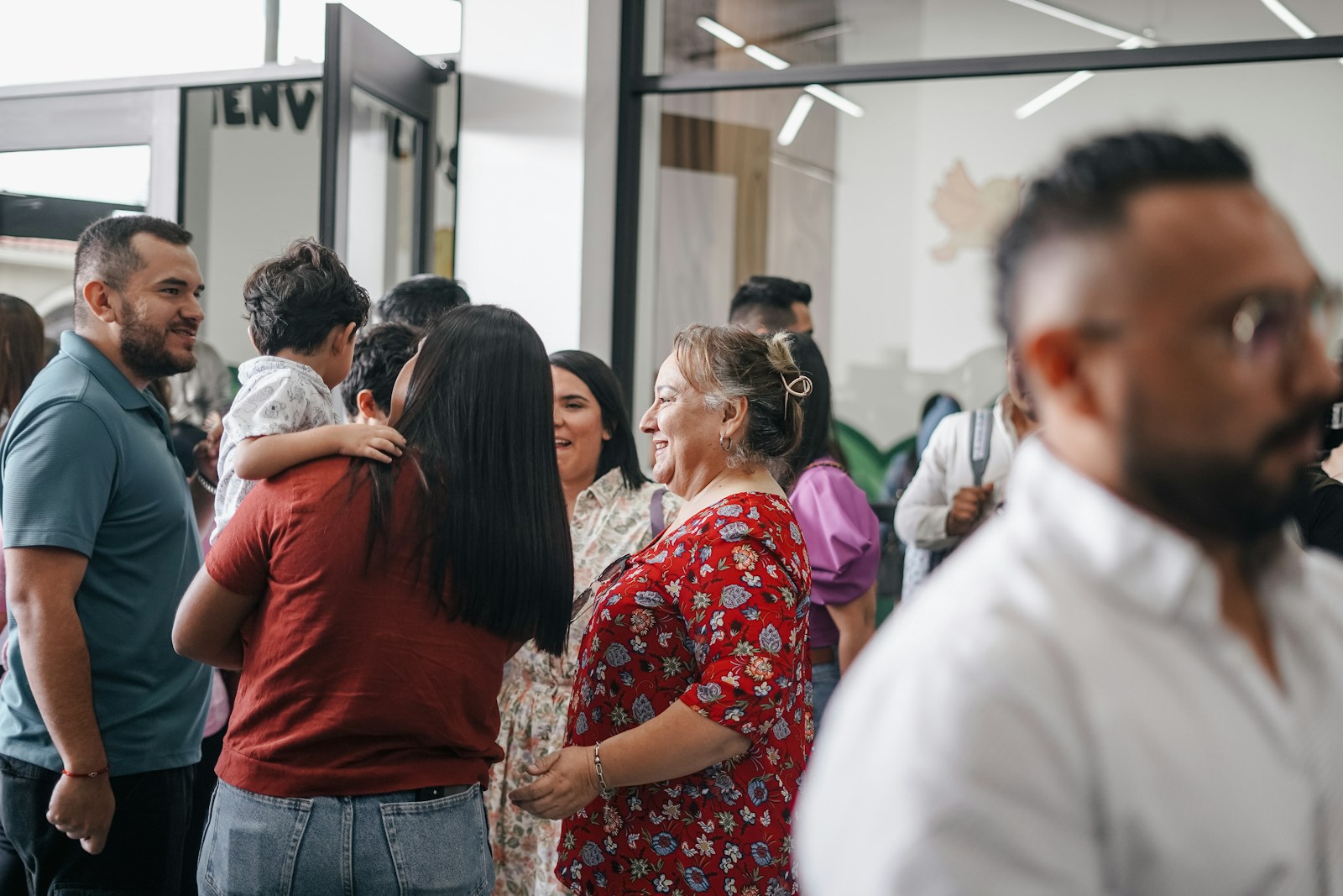 a group of people standing around each other